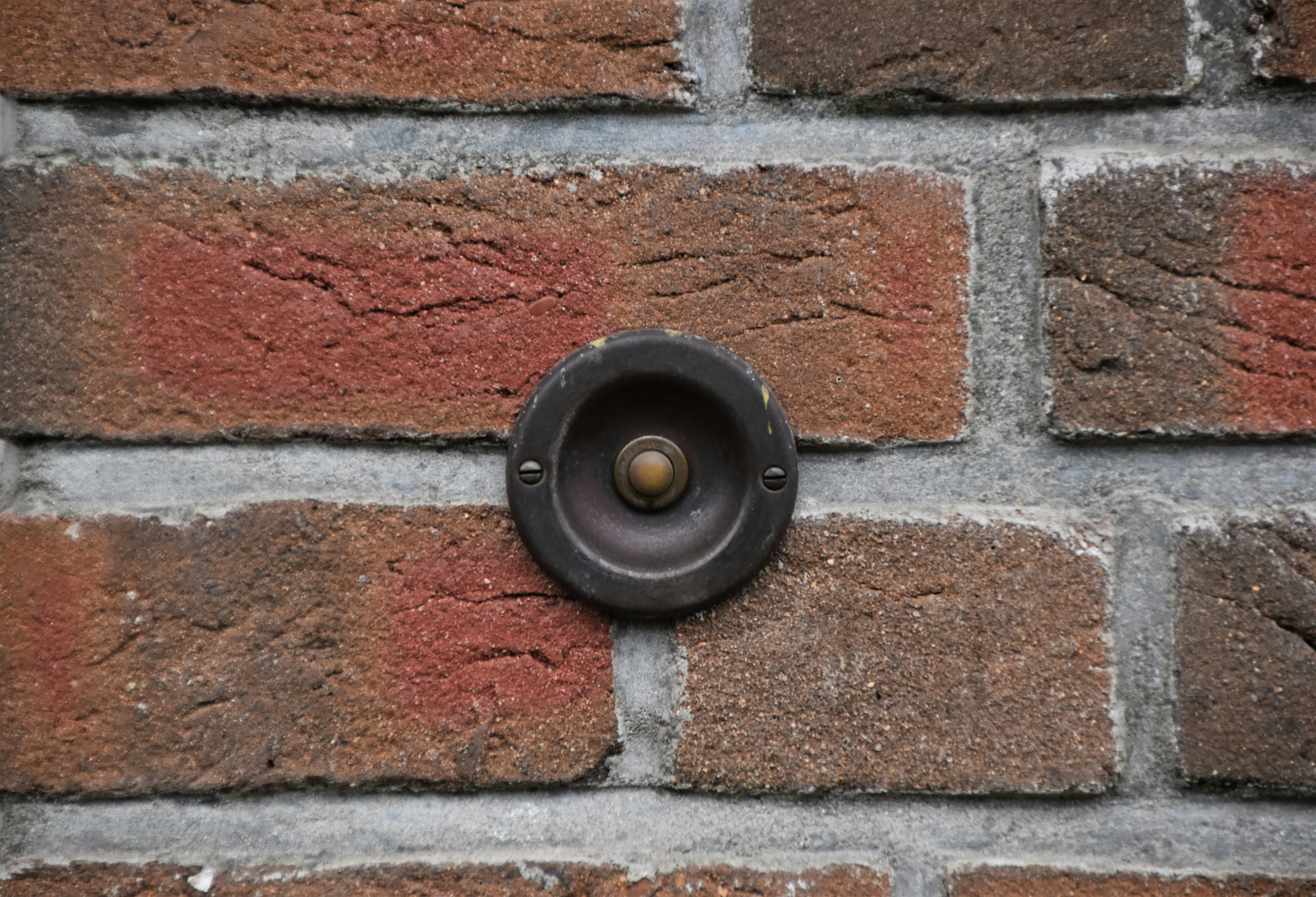 black round metal on brown brick wall